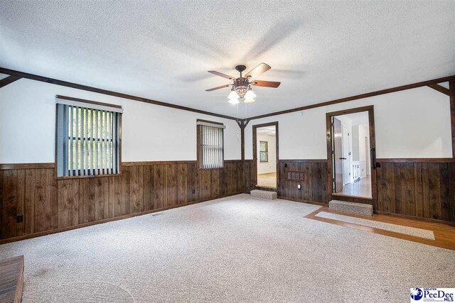 2 Bayswater Rd, Quinby, SC 29506 - spare room with ceiling fan, wooden walls, light carpet, and a textured ceiling