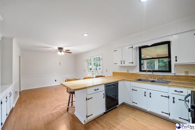 2 Bayswater Rd, Quinby, SC 29506 - kitchen featuring dishwasher, sink, a breakfast bar area, white cabinets, and kitchen peninsula