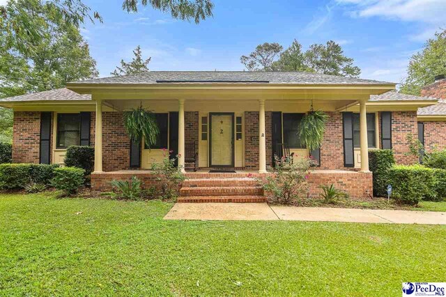 2 Bayswater Rd, Quinby, SC 29506 - ranch-style house with a front yard and covered porch