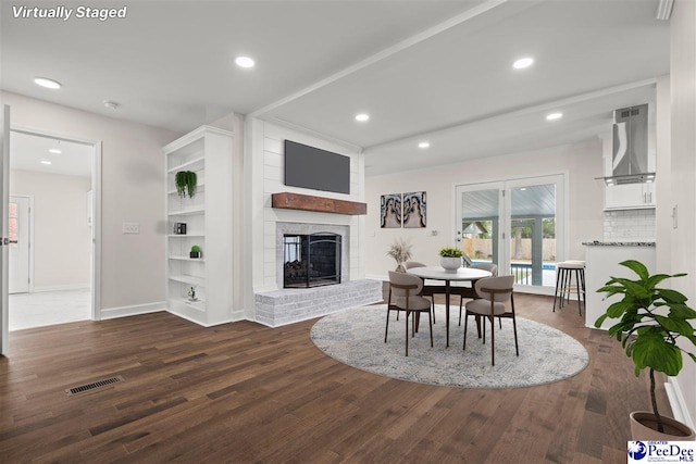 1844 Joseph Cir, Florence, SC 29501 - dining space with a brick fireplace, wood finished floors, recessed lighting, and baseboards