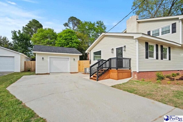 1844 Joseph Cir, Florence, SC 29501 - view of front of property featuring a detached garage, an outdoor structure, a chimney, and central AC unit