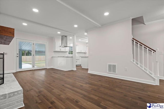 1844 Joseph Cir, Florence, SC 29501 - unfurnished living room with ornamental molding, dark wood-type flooring, healthy amount of natural light, recessed lighting, and stairway