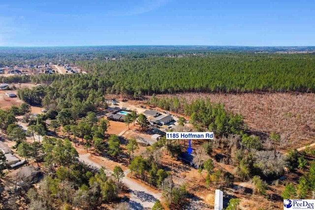 birds eye view of property with a wooded view