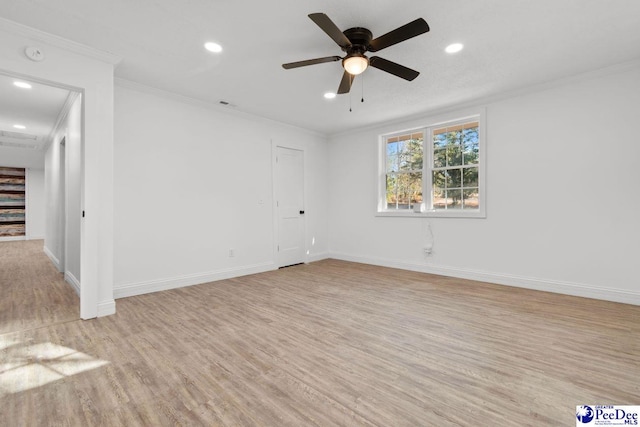 empty room featuring light wood-style flooring, baseboards, crown molding, and recessed lighting