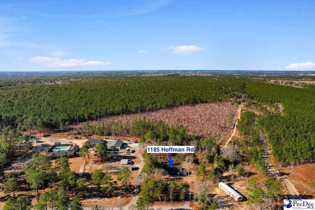 drone / aerial view with a wooded view