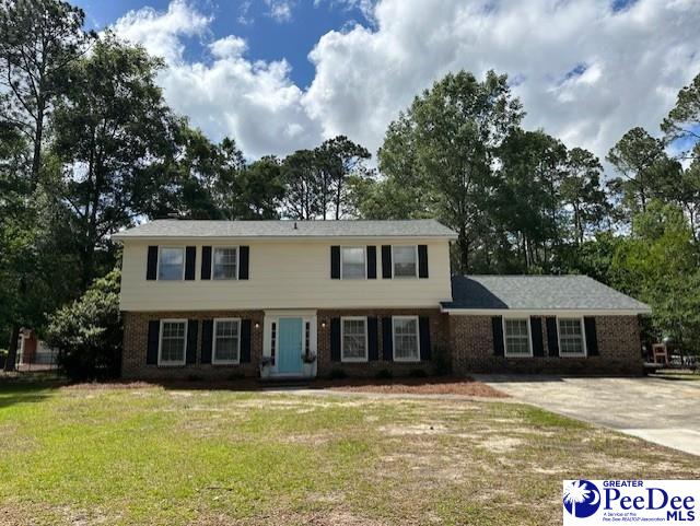 1328 Salem Rd, Hartsville, SC 29550 - view of front facade with a front yard, brick siding, and driveway