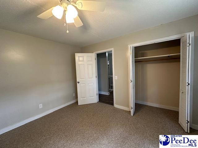 1328 Salem Rd, Hartsville, SC 29550 - unfurnished bedroom featuring carpet floors, baseboards, a closet, and a ceiling fan