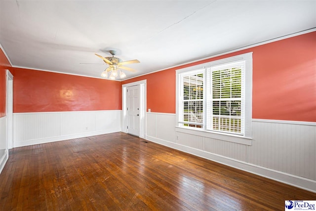 1461 King Ave, Florence, SC 29501 - unfurnished room with wood-type flooring, a wainscoted wall, a ceiling fan, and ornamental molding
