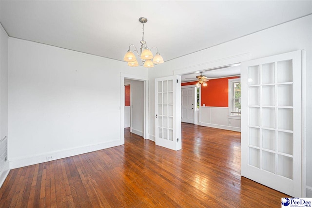 1461 King Ave, Florence, SC 29501 - unfurnished dining area featuring a ceiling fan, wood finished floors, french doors, a chandelier, and a wainscoted wall