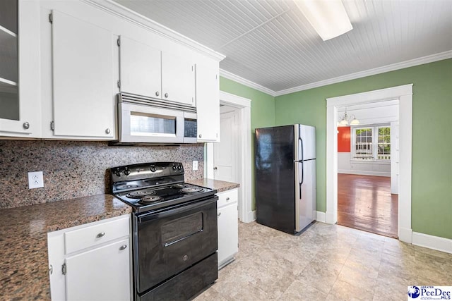 1461 King Ave, Florence, SC 29501 - kitchen with white microwave, freestanding refrigerator, electric range, white cabinetry, and tasteful backsplash