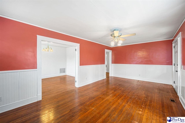 1461 King Ave, Florence, SC 29501 - spare room with a ceiling fan, a chandelier, wainscoting, hardwood / wood-style floors, and crown molding
