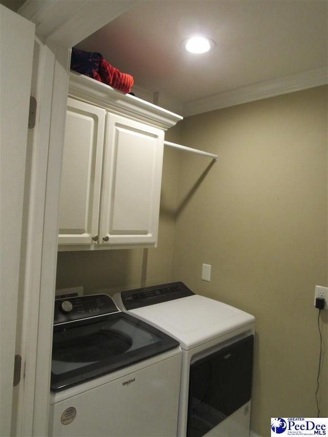 washroom featuring cabinet space, recessed lighting, separate washer and dryer, and ornamental molding