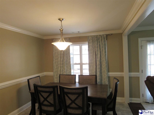 dining area featuring crown molding, a healthy amount of sunlight, visible vents, and baseboards