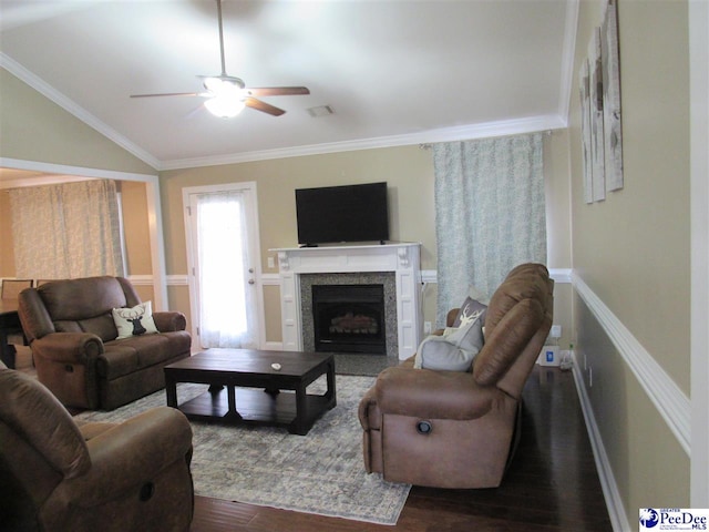 living area with dark wood finished floors, crown molding, a fireplace with flush hearth, and lofted ceiling