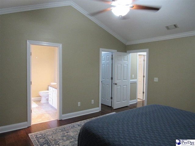 bedroom featuring wood finished floors, visible vents, baseboards, lofted ceiling, and crown molding