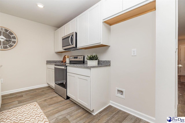 563 Strawberry Field Way, Galivants Ferry, SC 29544 - kitchen featuring appliances with stainless steel finishes, light wood-style floors, white cabinetry, recessed lighting, and light stone counters