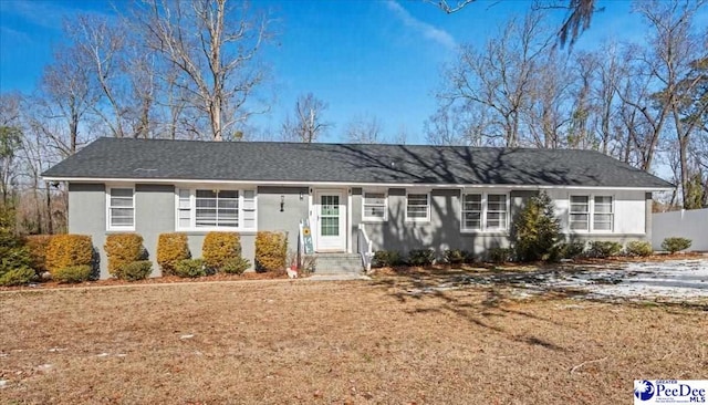 single story home featuring a front lawn