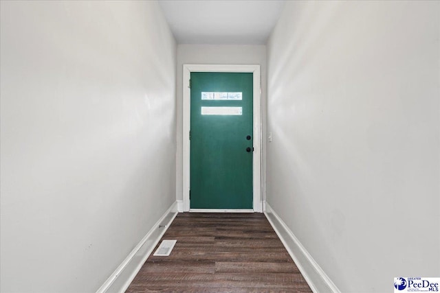 doorway to outside with dark wood-type flooring