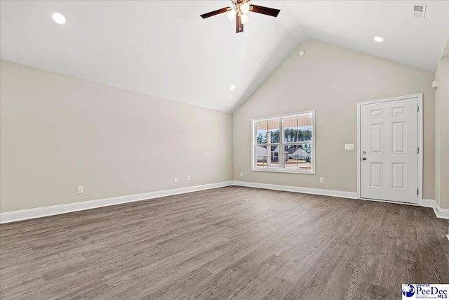 unfurnished living room featuring baseboards, visible vents, dark wood finished floors, ceiling fan, and high vaulted ceiling