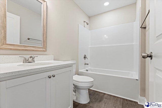 full bath with vanity, shower / washtub combination, wood finished floors, and toilet