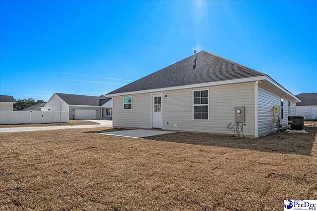 rear view of house featuring a yard, fence, cooling unit, and a patio