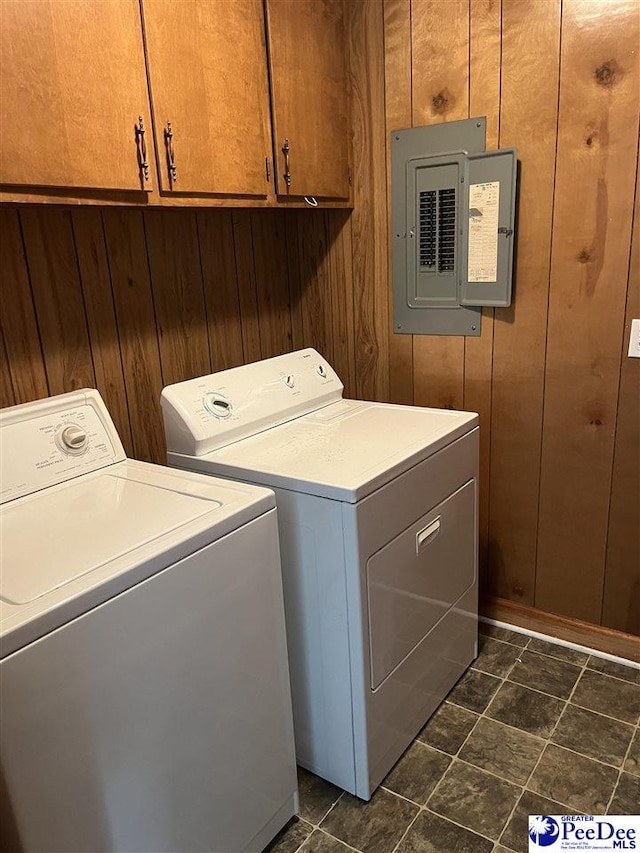 1840 New Zion Rd, Lake City, SC 29560 - laundry room featuring washer and dryer, electric panel, cabinet space, and wood walls