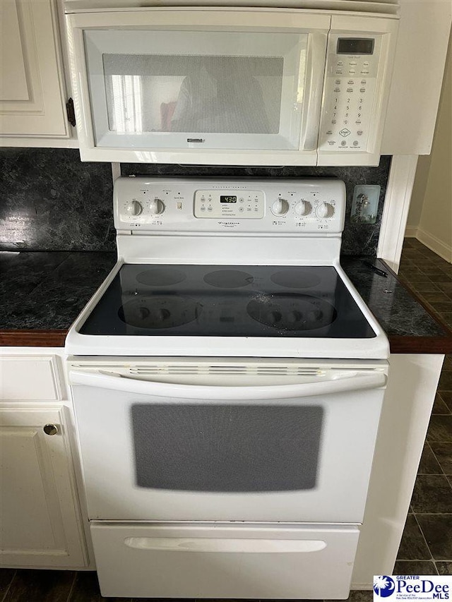 1840 New Zion Rd, Lake City, SC 29560 - kitchen with white appliances, dark countertops, decorative backsplash, and white cabinetry