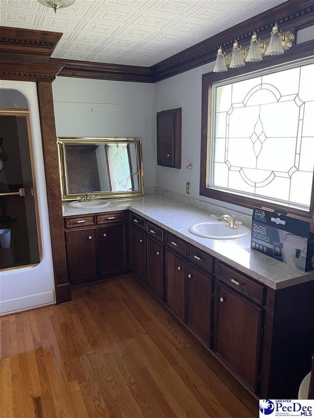 1840 New Zion Rd, Lake City, SC 29560 - kitchen with wood finished floors, light countertops, dark brown cabinets, an ornate ceiling, and crown molding