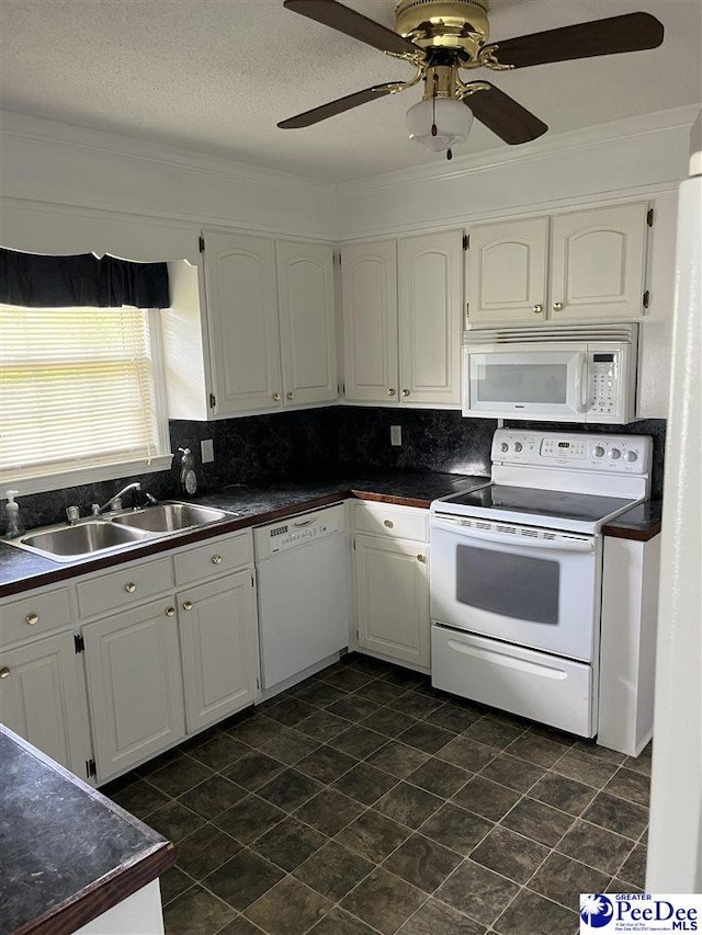 1840 New Zion Rd, Lake City, SC 29560 - kitchen with white appliances, dark countertops, a ceiling fan, crown molding, and a textured ceiling