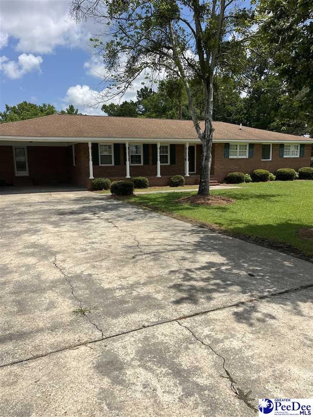 1840 New Zion Rd, Lake City, SC 29560 - ranch-style house with concrete driveway, a front lawn, and an attached carport