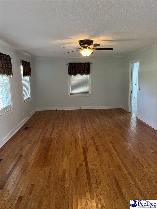 1840 New Zion Rd, Lake City, SC 29560 - empty room featuring wood finished floors, a textured ceiling, and a ceiling fan