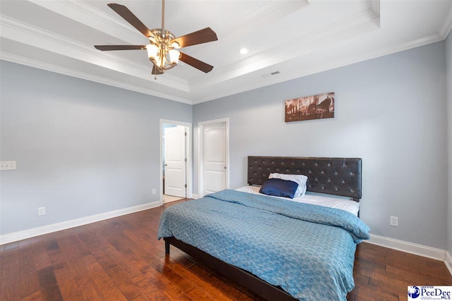bedroom with recessed lighting, hardwood / wood-style floors, baseboards, a raised ceiling, and crown molding