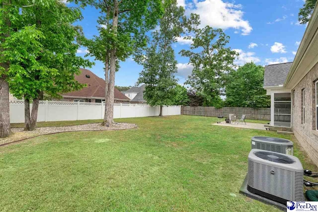 view of yard featuring cooling unit, a patio area, and a fenced backyard