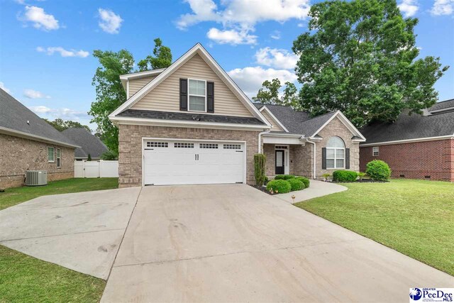 craftsman-style house featuring concrete driveway, fence, a front lawn, brick siding, and a garage