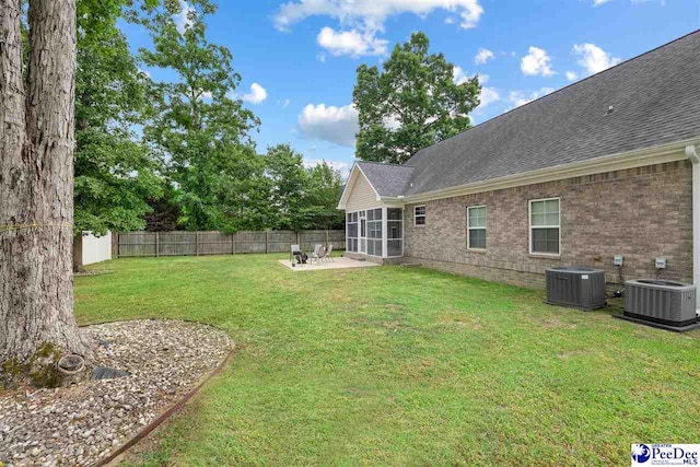 view of yard featuring central AC, a patio, and a fenced backyard