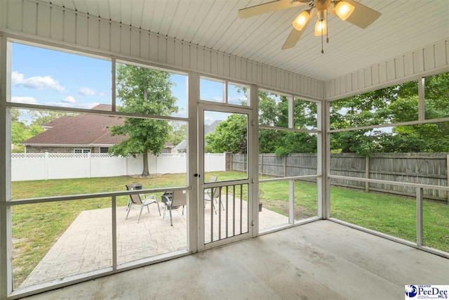 unfurnished sunroom with ceiling fan