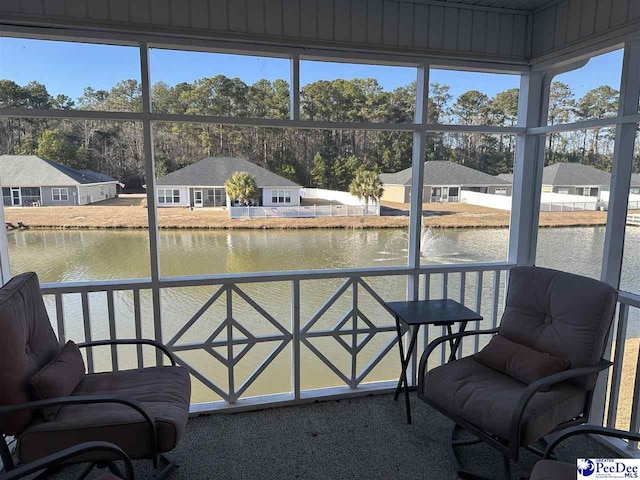 sunroom with a water view and a wealth of natural light