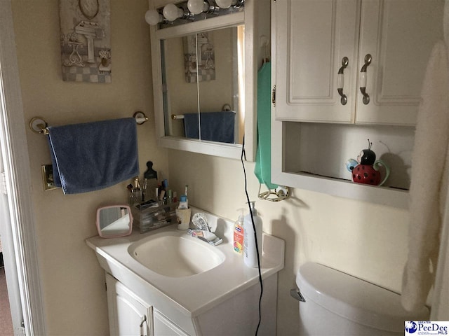 bathroom featuring vanity and toilet