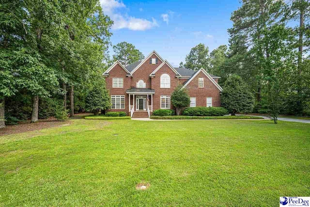3326 Tennyson Dr, Florence, SC 29501 - view of front facade featuring a front lawn and brick siding