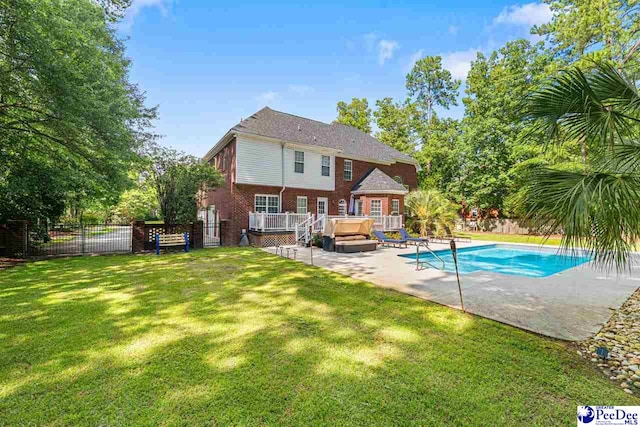 3326 Tennyson Dr, Florence, SC 29501 - back of house featuring a fenced backyard, a hot tub, a patio area, and brick siding