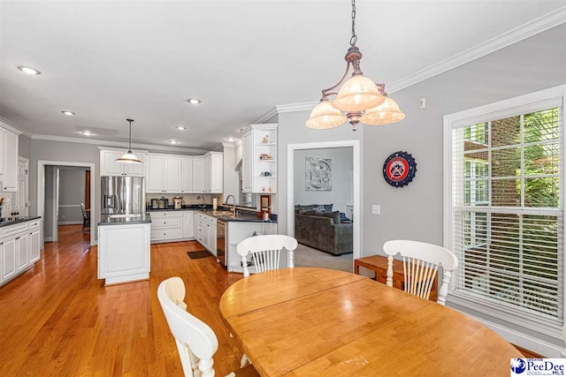 3326 Tennyson Dr, Florence, SC 29501 - dining area with crown molding, light wood finished floors, and recessed lighting