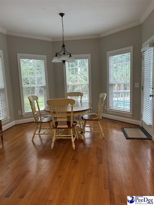 3326 Tennyson Dr, Florence, SC 29501 - dining area featuring light wood-type flooring, crown molding, and baseboards