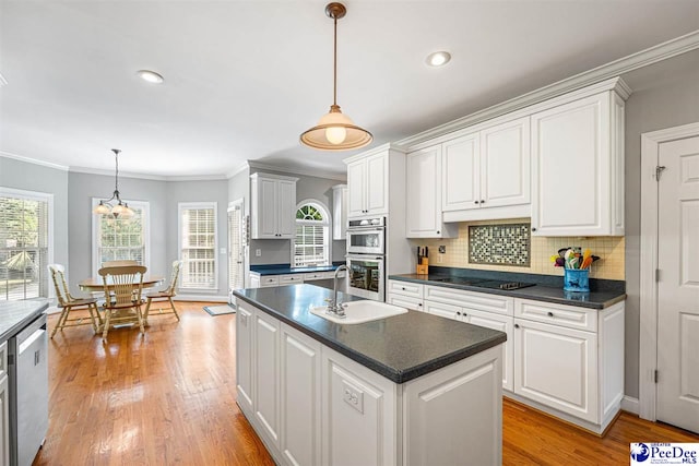 3326 Tennyson Dr, Florence, SC 29501 - kitchen featuring stainless steel appliances, white cabinets, dark countertops, plenty of natural light, and ornamental molding