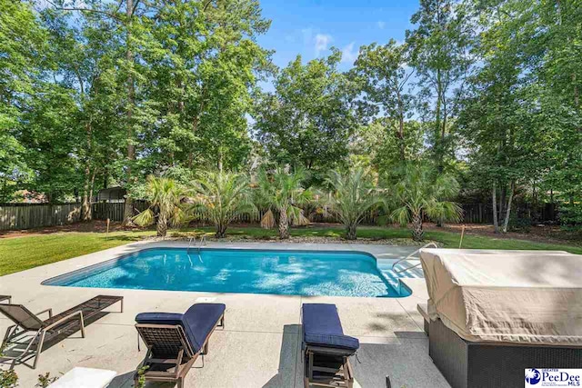 3326 Tennyson Dr, Florence, SC 29501 - view of swimming pool with a patio area, a fenced backyard, and view of wooded area