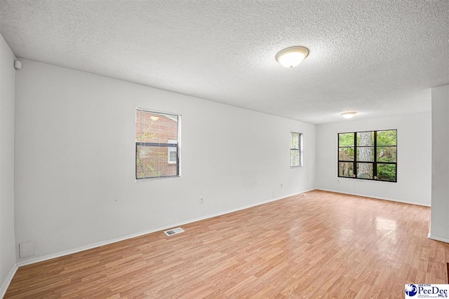 548 Mciver Rd, Florence, SC 29506 - spare room with baseboards, a textured ceiling, light wood-style flooring, and visible vents