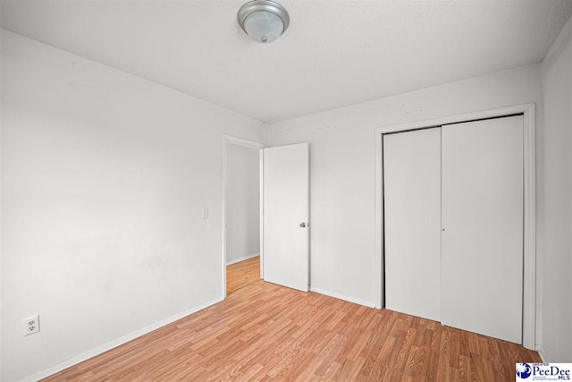 548 Mciver Rd, Florence, SC 29506 - unfurnished bedroom with a closet, baseboards, and light wood-style flooring