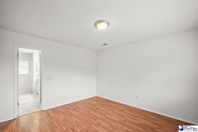 548 Mciver Rd, Florence, SC 29506 - empty room featuring visible vents, baseboards, light wood finished floors, and a textured ceiling
