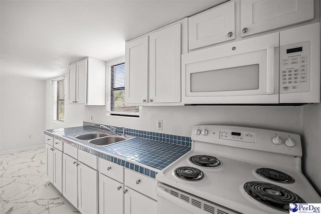 548 Mciver Rd, Florence, SC 29506 - kitchen featuring tile countertops, baseboards, marble finish floor, white appliances, and white cabinets