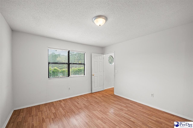 548 Mciver Rd, Florence, SC 29506 - spare room featuring baseboards, light wood-style floors, and a textured ceiling