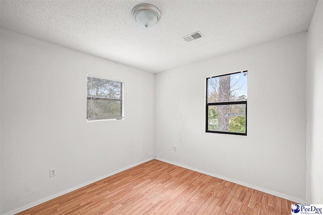 548 Mciver Rd, Florence, SC 29506 - unfurnished room with light wood finished floors, a wealth of natural light, and visible vents